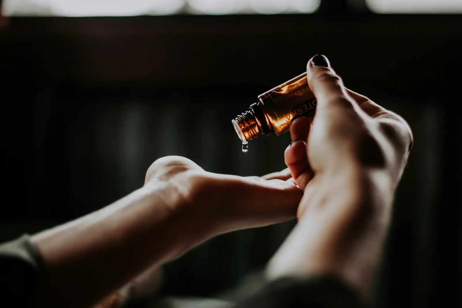 Eine Frau tropft Massageöl in ihre Handfläche, Closeup von Christin hume @ unsplash